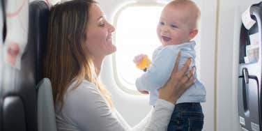 Mom holding her baby on an airplane