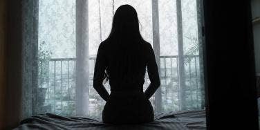 silhouette of a woman sitting