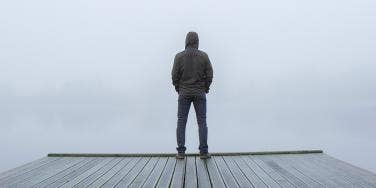 man standing alone on dock
