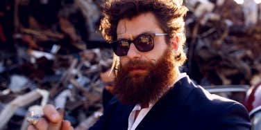 masculine guy with sunglasses and beard smoking cigar