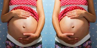 woman holding pregnant belly