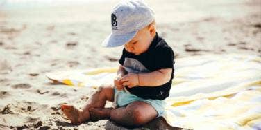 baby playing in the sand
