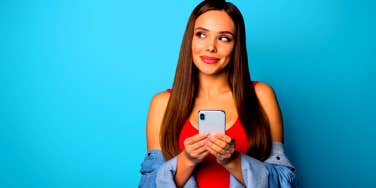 woman smiling a naughty smile while using sexting apps