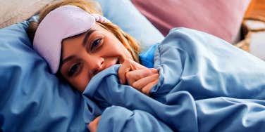 woman lying in bed with a face mask