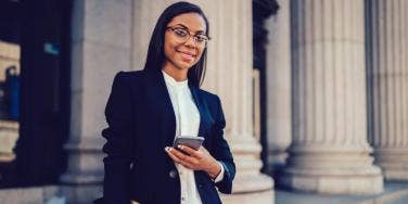 professional woman holding smartphone