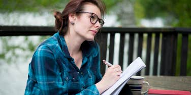 Woman writing notes in notebook 