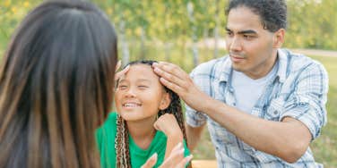 dad braiding daughter's hair 