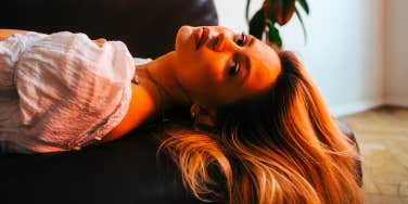 woman laying on couch with hair down