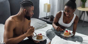 couple having pancakes in bed