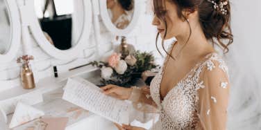 bride opening letter on her wedding day
