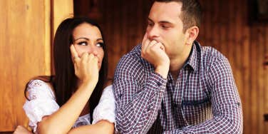 couple looking at each other during a fight trying to stay calm