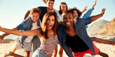 group of men and women friends having fun at the beach