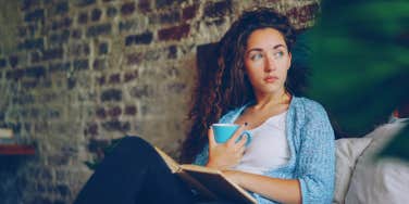 girl sitting in bed reading a book