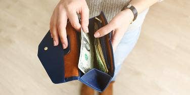 photo of woman opening wallet