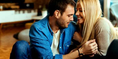 Affectionate couple enjoying while communicating and relaxing at home together