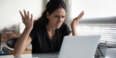 upset woman looking a job offer on computer