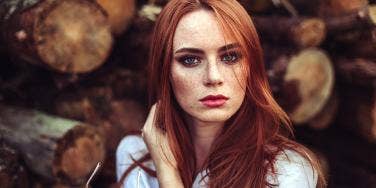 woman with red hair looking stern 