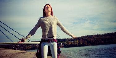 woman feeling the sun in her face with eyes closed