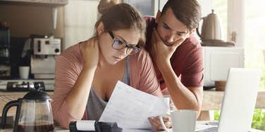 couple stressed about finances, barely make ends meet