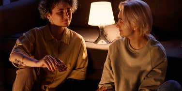 couple eating pizza in dark living room