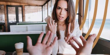 Woman setting boundary with demanding man while she takes a call