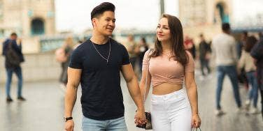 man and woman holding hands 