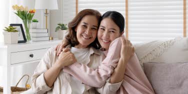 mom and daughter embracing on couch