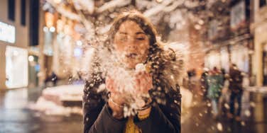 woman blowing snow away
