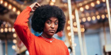 solemn woman touching her hair