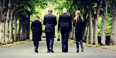four people walking away from a funeral