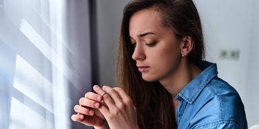 woman taking off wedding ring