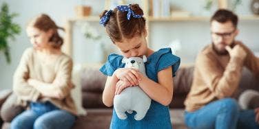 photo of upset daughter between mom and dad