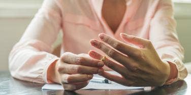 woman taking off wedding ring