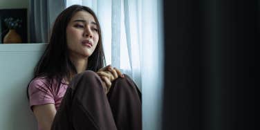 anxious woman sitting alone in room