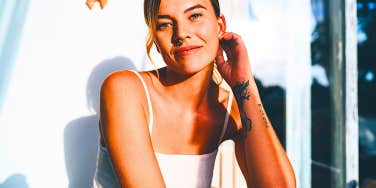 woman with tattoos looking at the camera