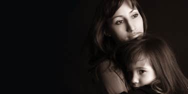mom holding young daughter