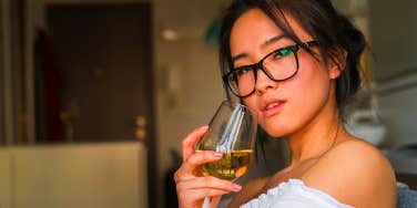 woman drinking wine on couch