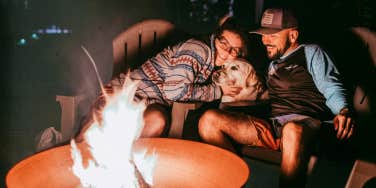 Couple enjoying time together by the campfire