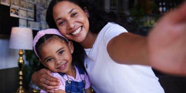 mom taking selfie with daughter