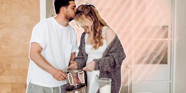 Couple cooking together, kissing in kitchen 