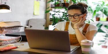woman looking at laptop in office