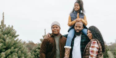 family with christmas trees
