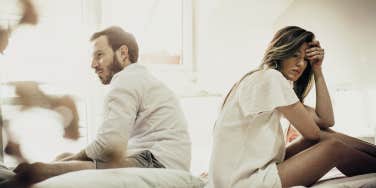 couple with their backs towards each other