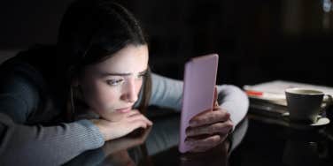 depressed teen girl with smartphone