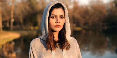 woman in gray hoodie looking at camera