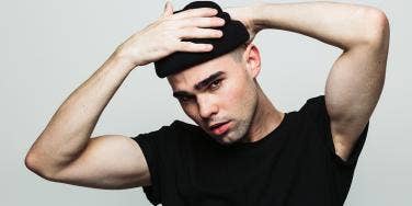 man with his hands on his head