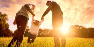 parents holding child's hand