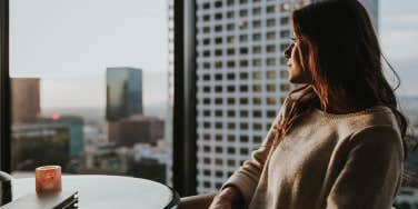 woman looking out a window