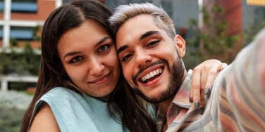 man and woman taking selfie