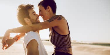 couple cuddling intimately in a desert 